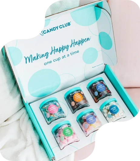 Custom-printed Candy Club box with matte finish and branded interior lid featuring logo and slogan, housing six individually labeled candy jars in die-cut compartments; vibrant packaging design highlights premium presentat