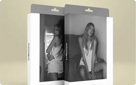 Minimalist SKIMS hang tab packaging with black-and-white product photography, vertical brand name along the side, and gray hanging tab for display. Inside: slip dress.
